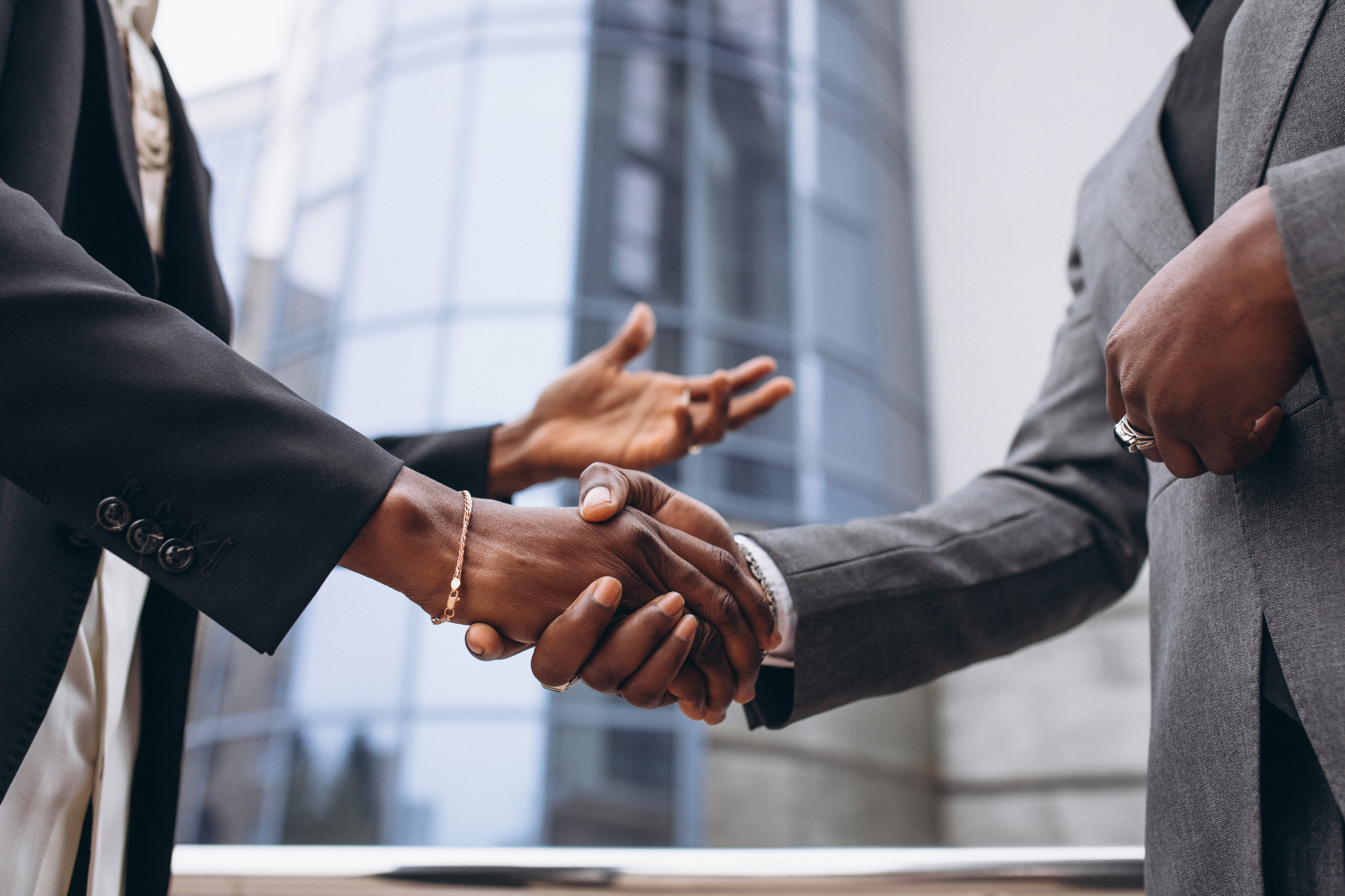 Handshake between two professionals in a bright office